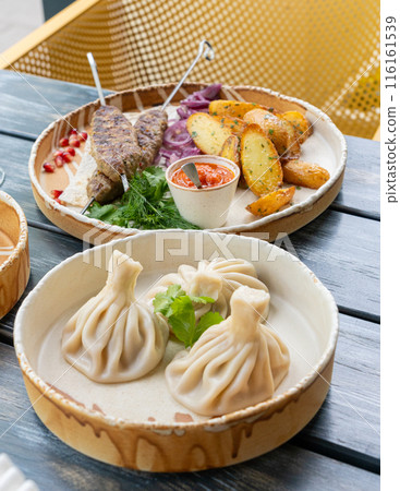 Georgian khinkali, minced meat chinkali, spicy dumplings also called dimsum, momo, jiaozi, manti 116161539