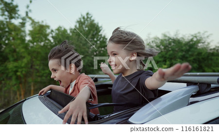 Funny Happy Little Boys Stands In Open Car Sunroof During Trip, Summer.Childhood 116161821