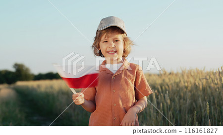 Polish little cute boy, national flag in field. Happy child, Poland national day 116161827
