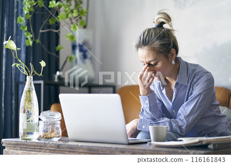 mature asian businesswoman working from home appearing to be frustrated and depressed 116161843