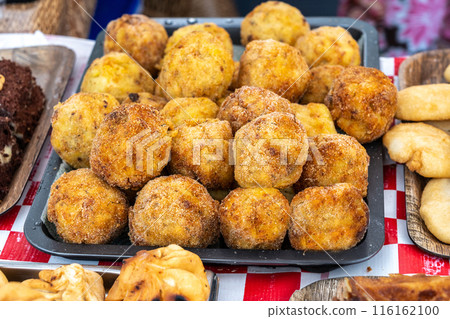Cheese potatoes fried balls, crispy croquettes stuffed with mozzarella, sphere fritters, thailand street food 116162100