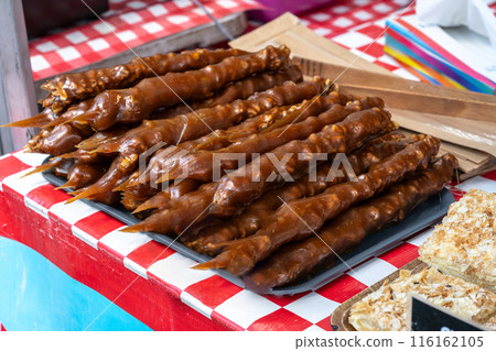 Traditional Georgian dessert churchkhela on display at market. Candies made from grape must, nuts, fruits 116162105