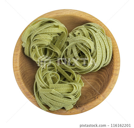 Raw tagliatelle green pasta with spinach in a wooden bowl isolated on white background. Top view. Flat lay. 116162201