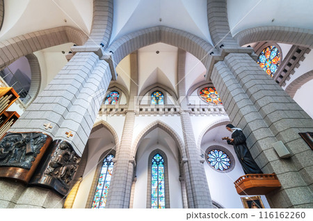 interior inside ancient Christian Catholic church with stained glass windows. Sacred Heart of Jesus Cathedral in Tashkent in Uzbekistan 116162260