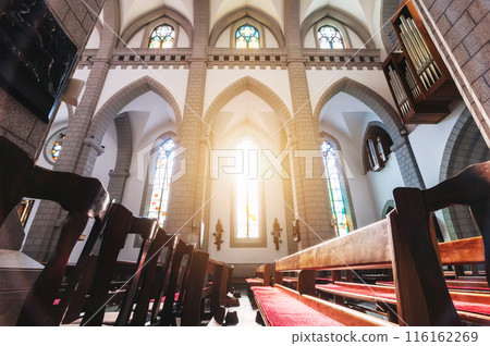 interior of Christian Roman Catholic church with pews and sunlight. Cathedral of Sacred Heart of Jesus in Tashkent in Uzbekistan interior of Christian Roman Catholic church with pews and sunlight. Cathedral of Sacred Heart of Jesus in Tashkent in Uzbekistan 116162269