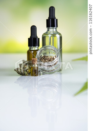 Bottles of cbd oil, marijuana and hemp leaves 116162407