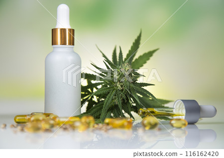 Hemp oil and cannabis leaves on light background Hemp oil and cannabis leaves on light background 116162420