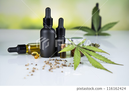 Bottles of cbd oil, marijuana and hemp leaves Bottles of cbd oil, marijuana and hemp leaves 116162424