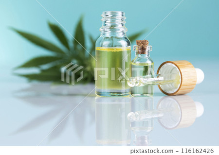 Hemp cbd oil, cannabis leaves, hemp seeds and bottles of oil 116162426