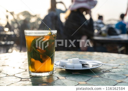 Moroccan Mint Tea in Teapot and Glass, Traditional Morocco Drink Moroccan Mint Tea in Teapot and Glass, Traditional Morocco Drink 116162584
