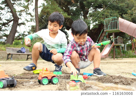 Children playing in the sandbox Children playing in the sandbox 116163008