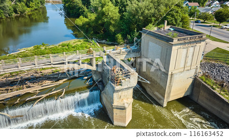 Rusty Maumee River Dam wheel above tree logs under bridge choking waterfall aerial Fort Wayne, IN 116163452