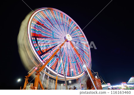 Ferris Wheel Light Trails at Night, Carnival Energy, Low Angle View Ferris Wheel Light Trails at Night, Carnival Energy, Low Angle View 116163460