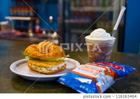 Casual Cafe Dining with Croissant Sandwich, Iced Beverage, and Chips Casual Cafe Dining with Croissant Sandwich, Iced Beverage, and Chips 116163464