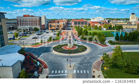 Passing of the Buffalo statue beside Canan Commons Park aerial of city on gorgeous day, Muncie IN 116163483