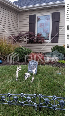 Suburban Halloween Graveyard Decor with Spooky House Background 116163535