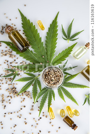Hemp oil bottle with hemp leaf and cannabis leaf, marijuana Hemp oil bottle with hemp leaf and cannabis leaf, marijuana 116163619