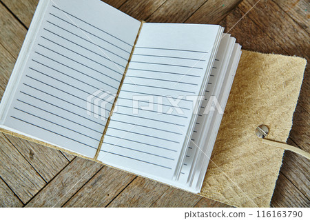 Artisanal Suede Leather Notebook on Wooden Surface, Top View Artisanal Suede Leather Notebook on Wooden Surface, Top View 116163790
