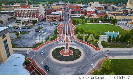 Muncie, IN aerial roundabout with Passing of the Buffalo statue and Canan Commons Park at sunset 116163797