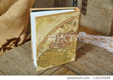 Vintage Map Cover Hardcover on Wooden Surface Vintage Map Cover Hardcover on Wooden Surface 116163884