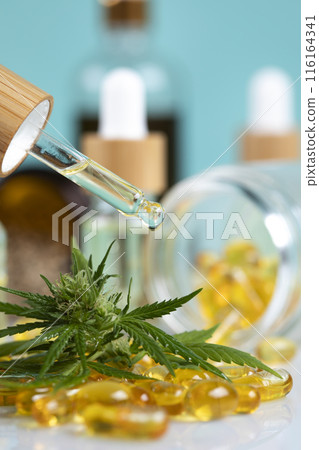 Marijuana oil, leaf and capsules on a white background Marijuana oil, leaf and capsules on a white background 116164341