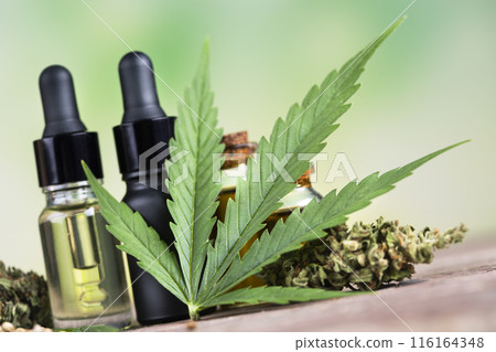 Bottles with hemp oil and cannabis leaves, marijuana Bottles with hemp oil and cannabis leaves, marijuana 116164348