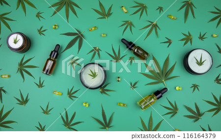 Flat lay composition of marijuana and hemp seeds on green color paper background 116164379