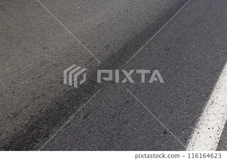 white road markings on asphalt, close up 116164623