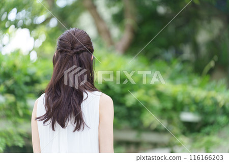 Fresh greenery and the back of a young woman Fresh greenery and the back of a young woman 116166203