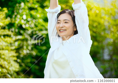 Portrait of a middle-aged woman stretching in the sunlight Portrait of a middle-aged woman stretching in the sunlight 116166601