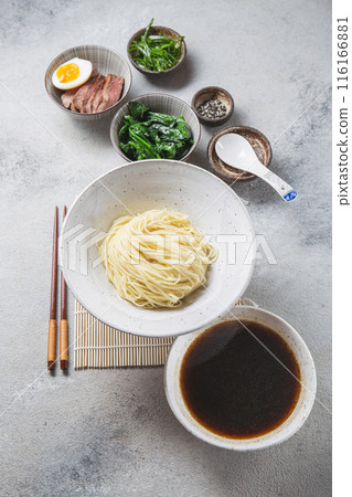Ingredients for ramen displayed on a light background include ramen noodles, soft-boiled egg, sliced meat, spinach Ingredients for ramen displayed on a light background include ramen noodles, soft-boiled egg, sliced meat, spinach 116166881