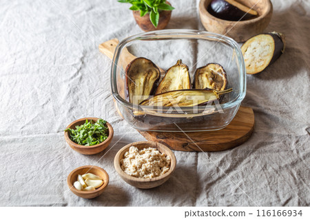 Ingridients for Jewish eggplant baba ganoush on wooden board. Ingridients for Jewish eggplant baba ganoush on wooden board. 116166934