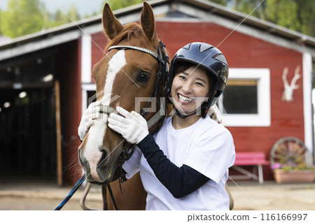 Woman enjoying horse riding Woman enjoying horse riding 116166997