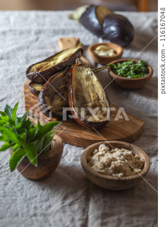Ingridients for Jewish eggplant baba ganoush on wooden board. 116167048