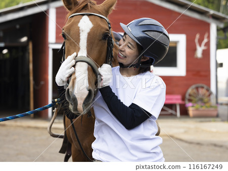 Woman enjoying horse riding Woman enjoying horse riding 116167249