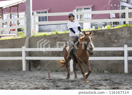 Woman enjoying horse riding 116167314
