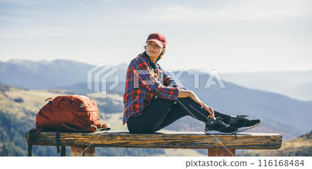 Female Hiker Resting on Bench in Scenic Mountain View 116168484