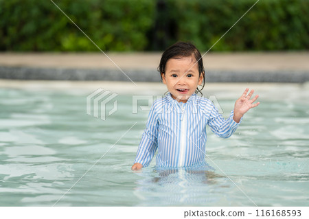 toddler baby playing and waving goodbye in swimming pool 116168593