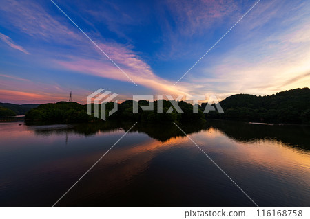 Evening view of Nunome Dam in the summer of 2024. Wide-angle shot from before sunset through golden hour to blue hour. Golden hour ⑦ 116168758