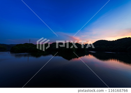 Evening view of Nunome Dam in the summer of 2024. Wide-angle shot from before sunset through golden hour to blue hour. Golden hour ⑮ Evening view of Nunome Dam in the summer of 2024. Wide-angle shot from before sunset through golden hour to blue hour. Golden hour ⑮ 116168766