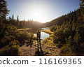 Silhouette of Woman at Lakeside in Carpathian Mountains at Dawn 116169365