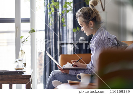 mature asian woman working from home using notebook computer 116169389
