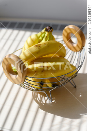 Several ripe bananas in a fruit basket. View from above. 116169544