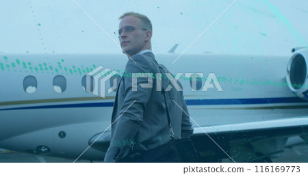 Image of graph and changing numbers over caucasian man with bag walking towards airplane Image of graph and changing numbers over caucasian man with bag walking towards airplane 116169773