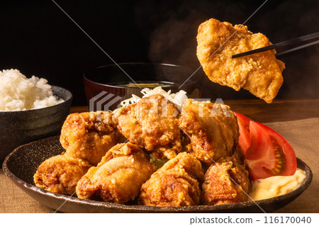 Fried chicken lifted with chopsticks Fried chicken lifted with chopsticks 116170040
