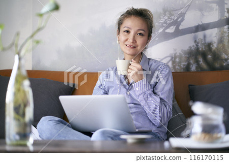 mature asian woman working from home using notebook computer 116170115