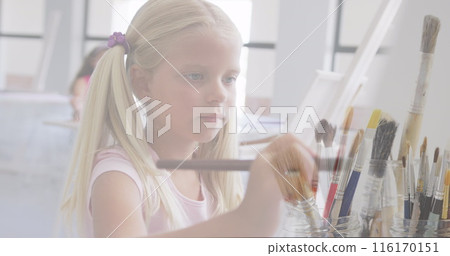 Image of paint brushes over caucasian schoolgirl painting in art class Image of paint brushes over caucasian schoolgirl painting in art class 116170151