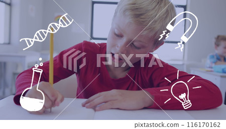 Image of science icons over happy caucasian schoolboy working at desk 116170162