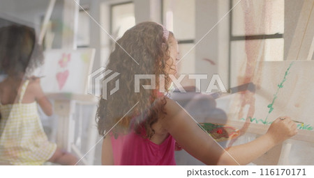 Image of hand using paint brush over diverse schoolgirls painting at easels in art class Image of hand using paint brush over diverse schoolgirls painting at easels in art class 116170171