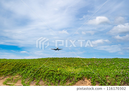 Airplane landing at Phuket airport Thailand,Flight over beach sea background Airplane landing at Phuket airport Thailand,Flight over beach sea background 116170302